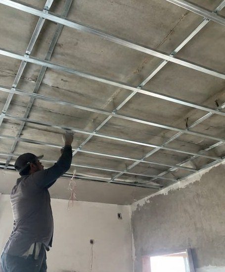 Technician fixing the metal channel frame for a false ceiling